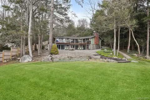 a view of a house with backyard and a tree