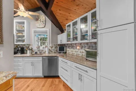a kitchen with stainless steel appliances granite countertop a sink and cabinets