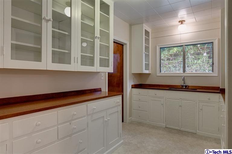 1255 Wentworth Avenue Pasadena, CA 91106 - Photo 24 of 44 a kitchen with granite countertop white cabinets and a sink