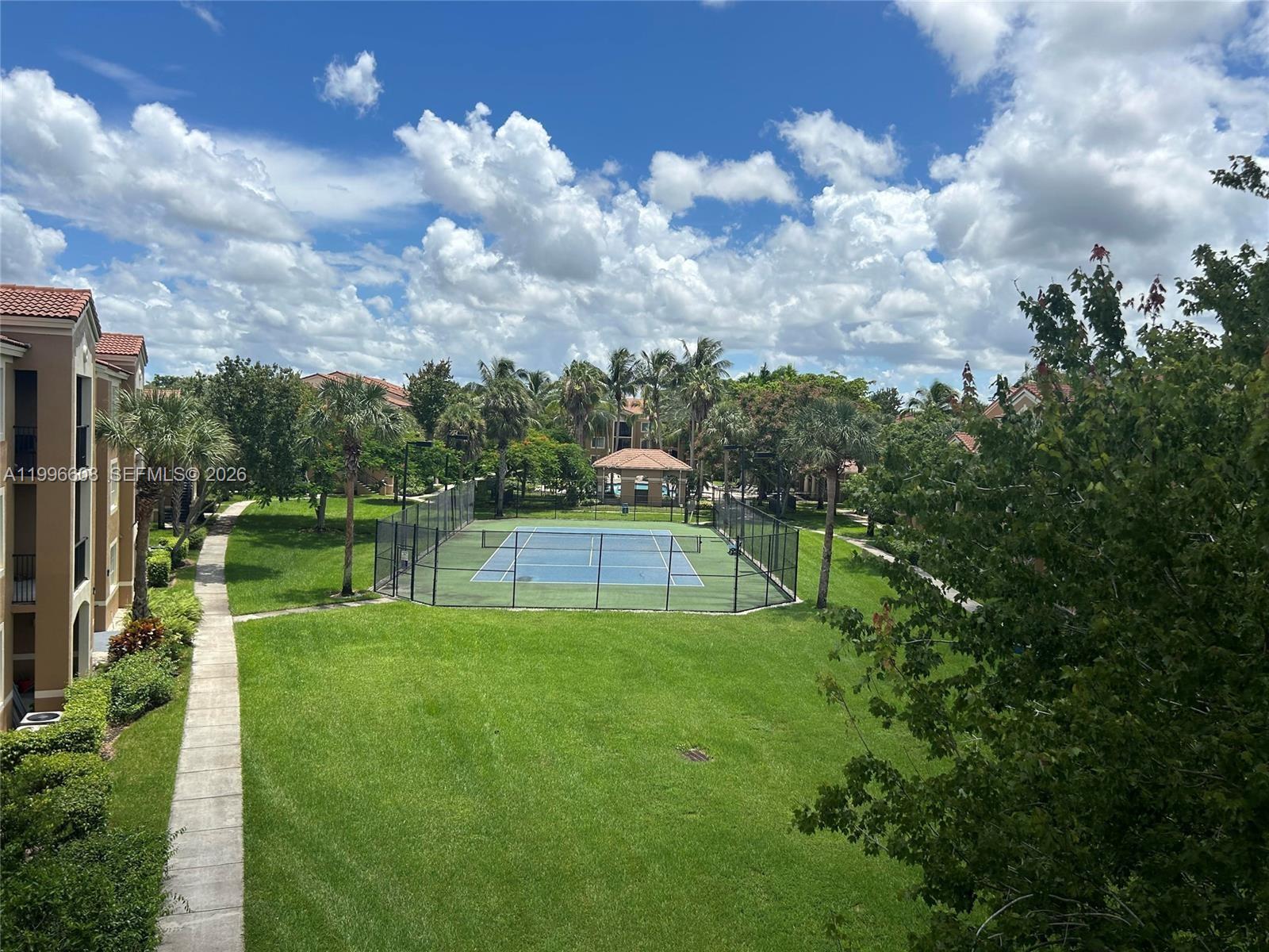 8050 North Nob Hill Road, Unit 203 Tamarac, FL 33321 - Photo 7 of 9 a view of a lake with a big yard