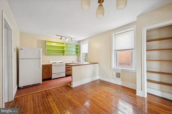 a kitchen with a refrigerator and a stove top oven