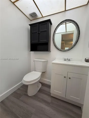a bathroom with a toilet a sink and a mirror