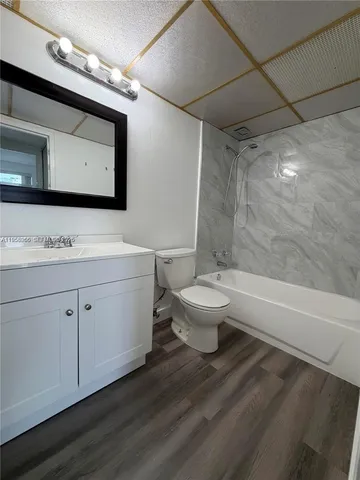 a bathroom with a double vanity sink mirror and toilet