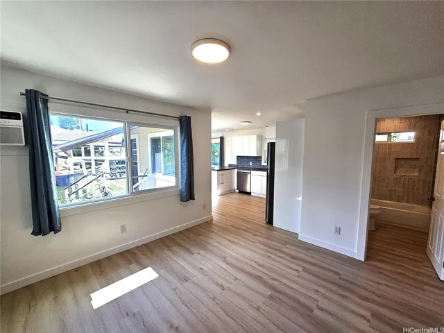 wooden floor in an empty room with a window