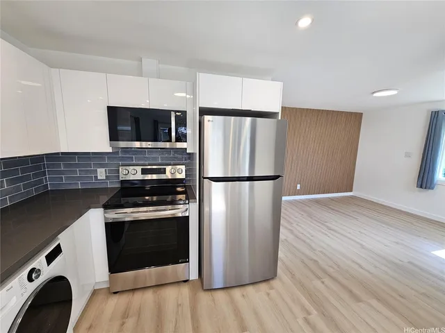 a kitchen with a refrigerator stove and microwave