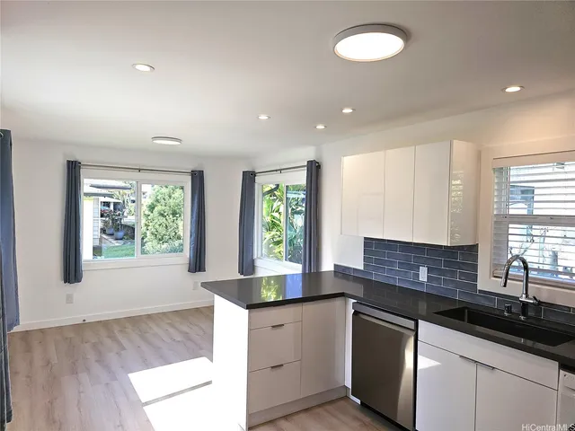 a kitchen with granite countertop a sink and a window