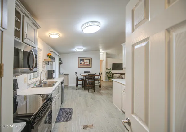 a kitchen with a sink stainless steel appliances and furniture