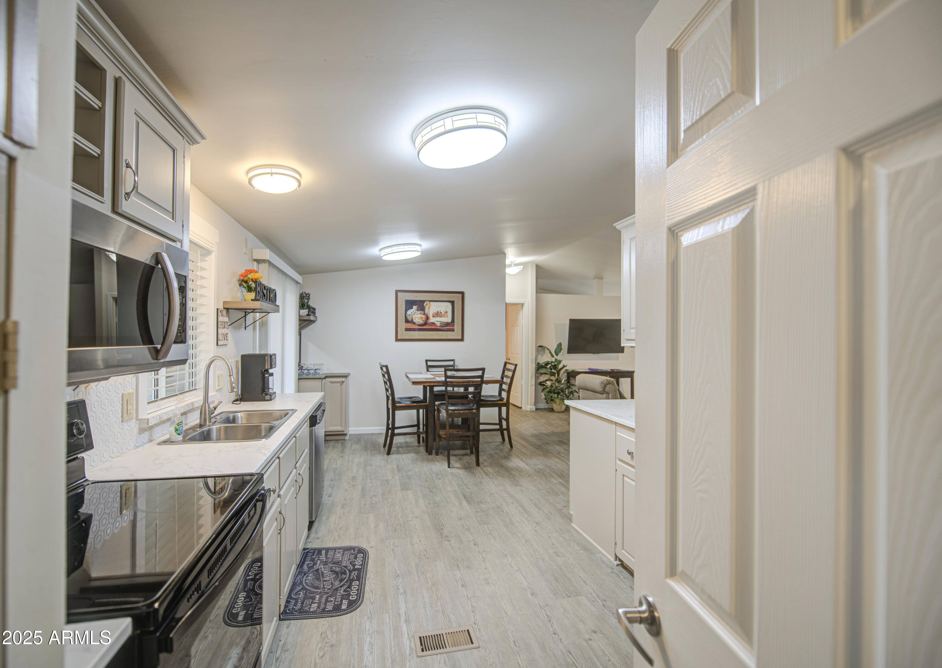 2208 West Baseline Avenue, Unit 67 Apache Junction, AZ 85120 - Photo 18 of 41 a kitchen with a sink stainless steel appliances and furniture