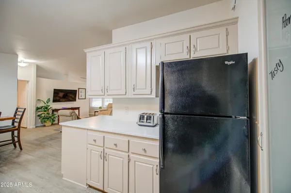 a kitchen with a refrigerator and a sink