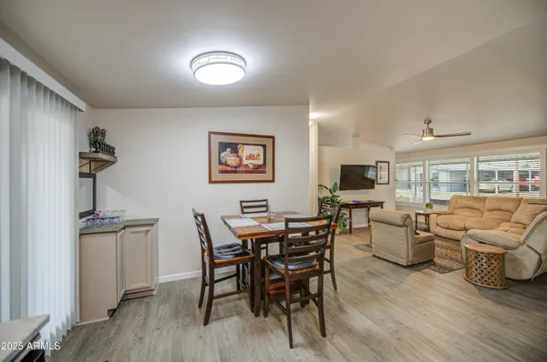 a view of a dining room with furniture and wooden floor