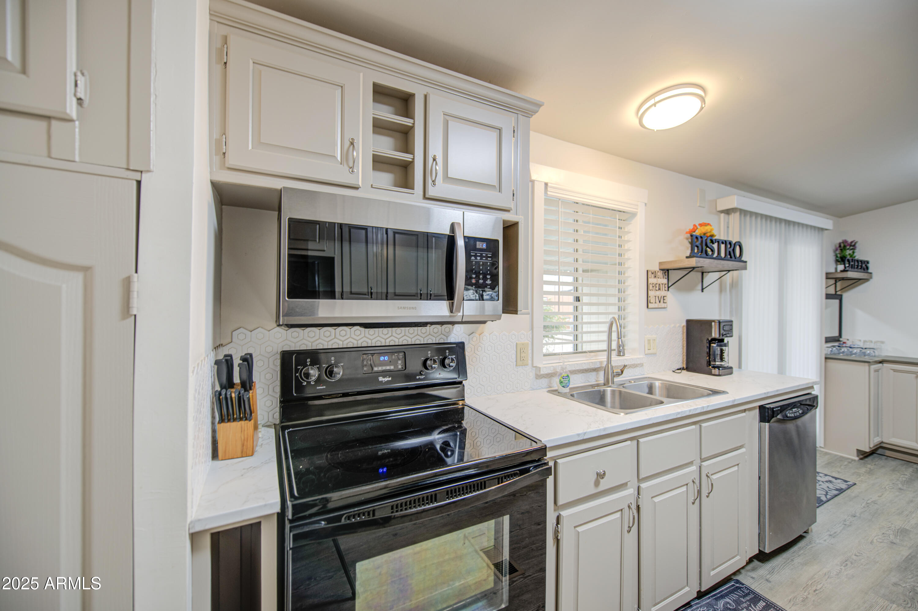 2208 West Baseline Avenue, Unit 67 Apache Junction, AZ 85120 - Photo 2 of 41 a kitchen with a sink stove and microwave
