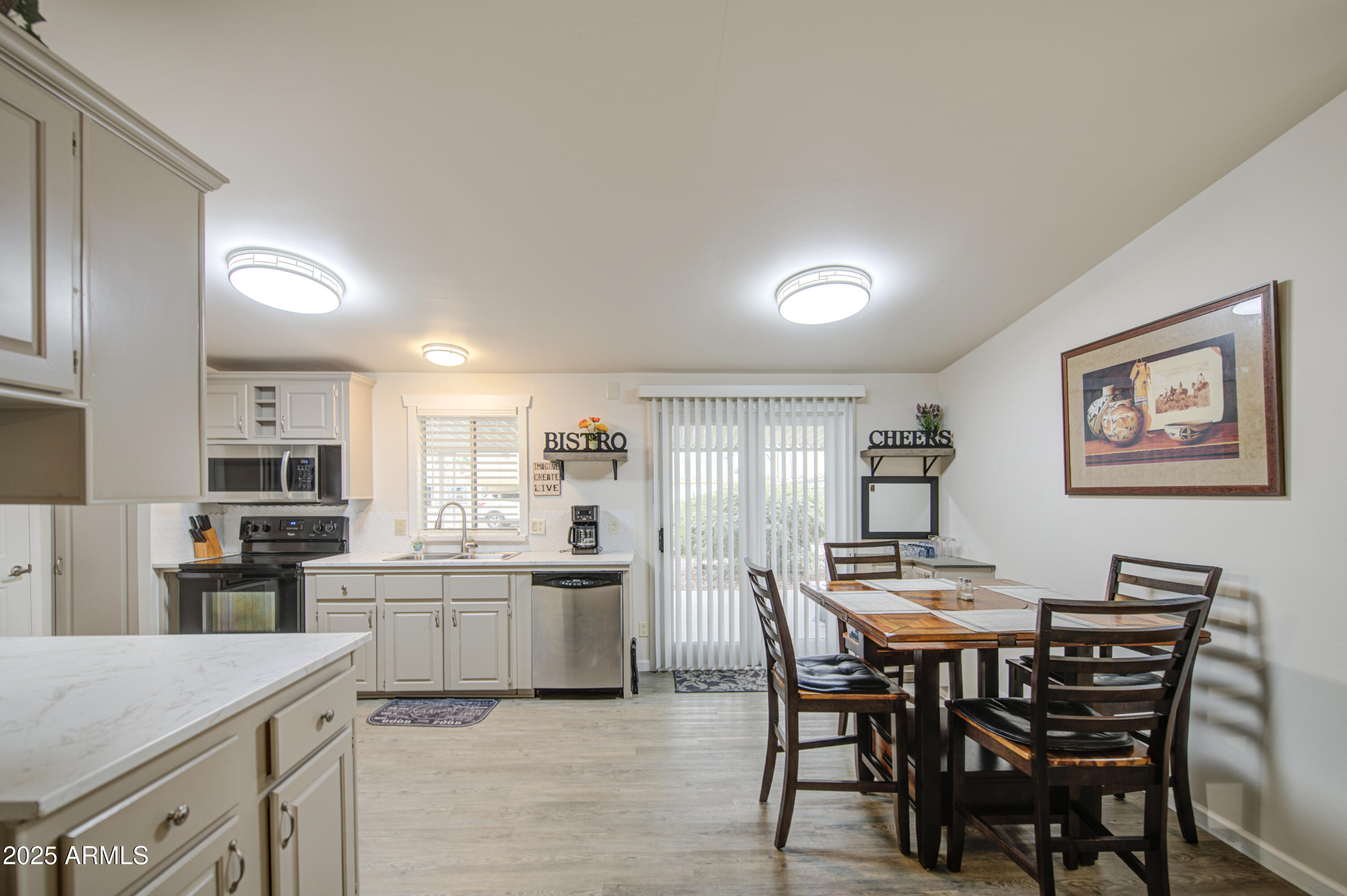 2208 West Baseline Avenue, Unit 67 Apache Junction, AZ 85120 - Photo 23 of 41 a kitchen with a dining table chairs and refrigerator