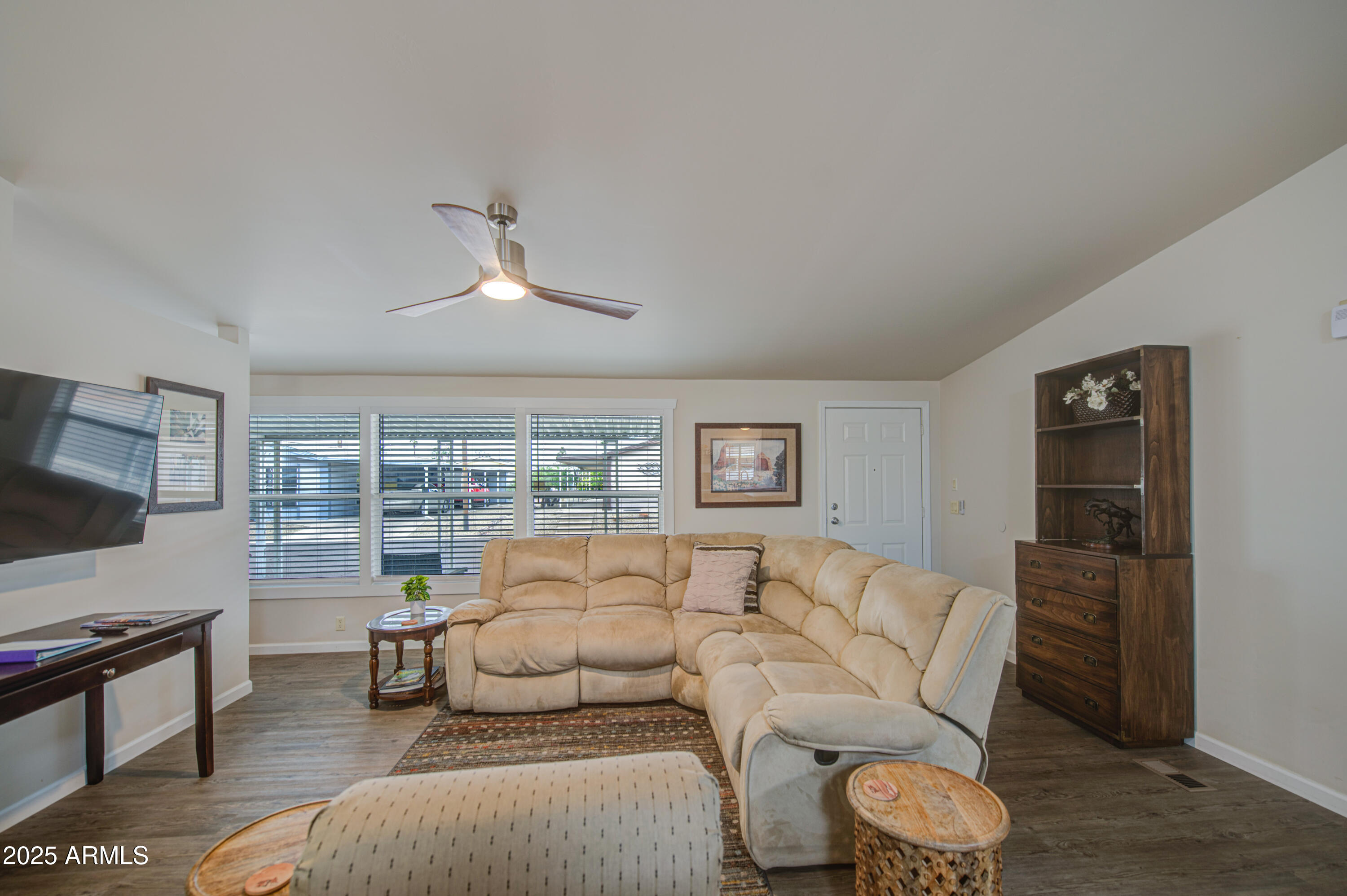2208 West Baseline Avenue, Unit 67 Apache Junction, AZ 85120 - Photo 26 of 41 a living room with furniture and a flat screen tv