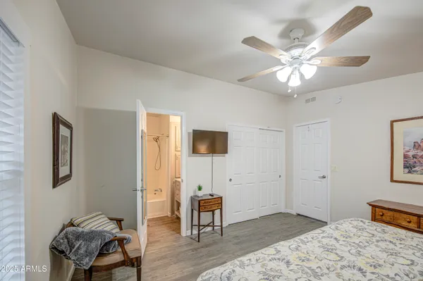 a bedroom with a large bed and a chandelier