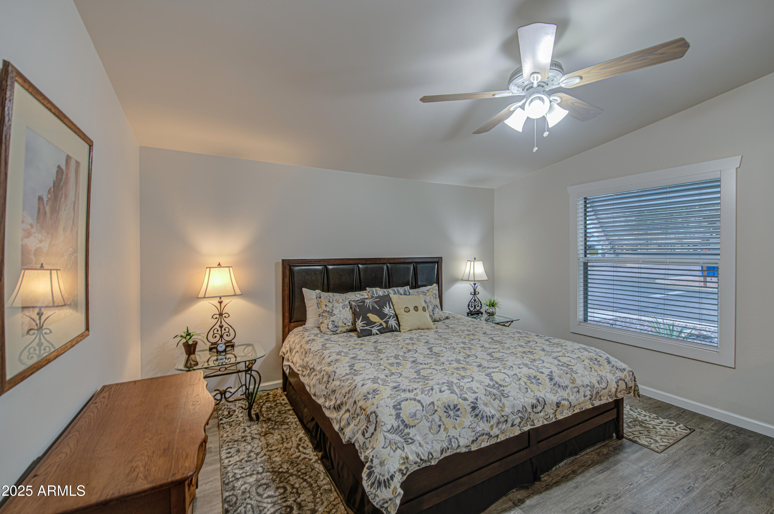 2208 West Baseline Avenue, Unit 67 Apache Junction, AZ 85120 - Photo 4 of 41 a bedroom with a bed and a chandelier