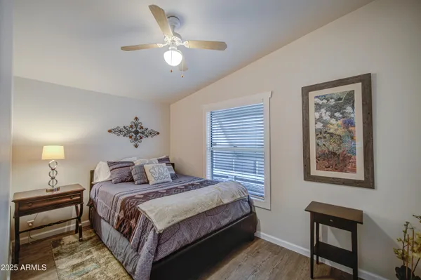 a bedroom with a large bed and a chandelier