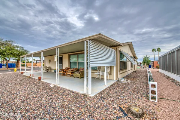 a view of a house with a backyard