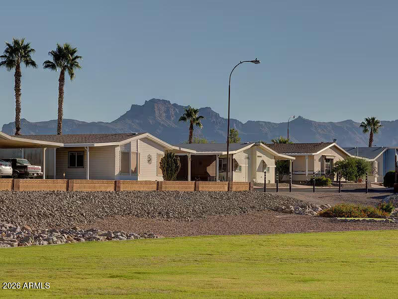 2208 West Baseline Avenue, Unit 67 Apache Junction, AZ 85120 - Photo 9 of 41 a front view of a house with a garden