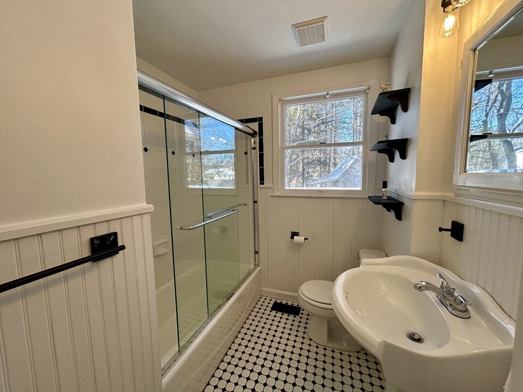 63 Conant Street Acton, MA 01720 - Photo 13 of 30 a bathroom with a sink a toilet and shower