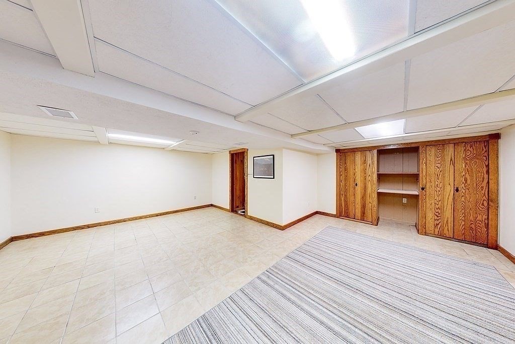 63 Conant Street Acton, MA 01720 - Photo 17 of 30 a view of an empty room with a window