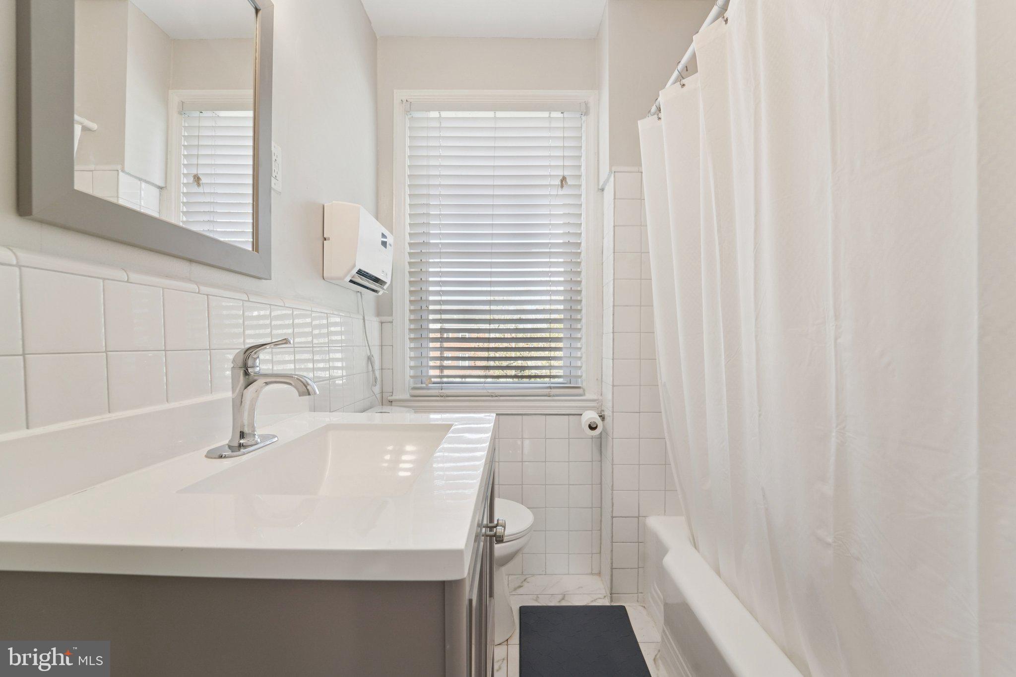 5701 The Alameda Baltimore, MD 21239 - Photo 15 of 29 a bathroom with a sink and a bathtub