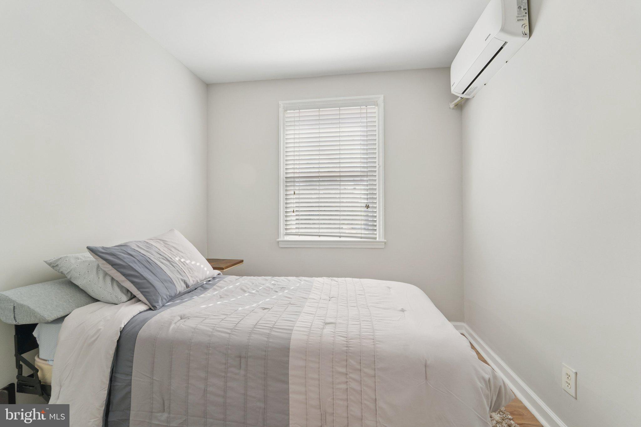 5701 The Alameda Baltimore, MD 21239 - Photo 17 of 29 a bedroom with a bed and a window