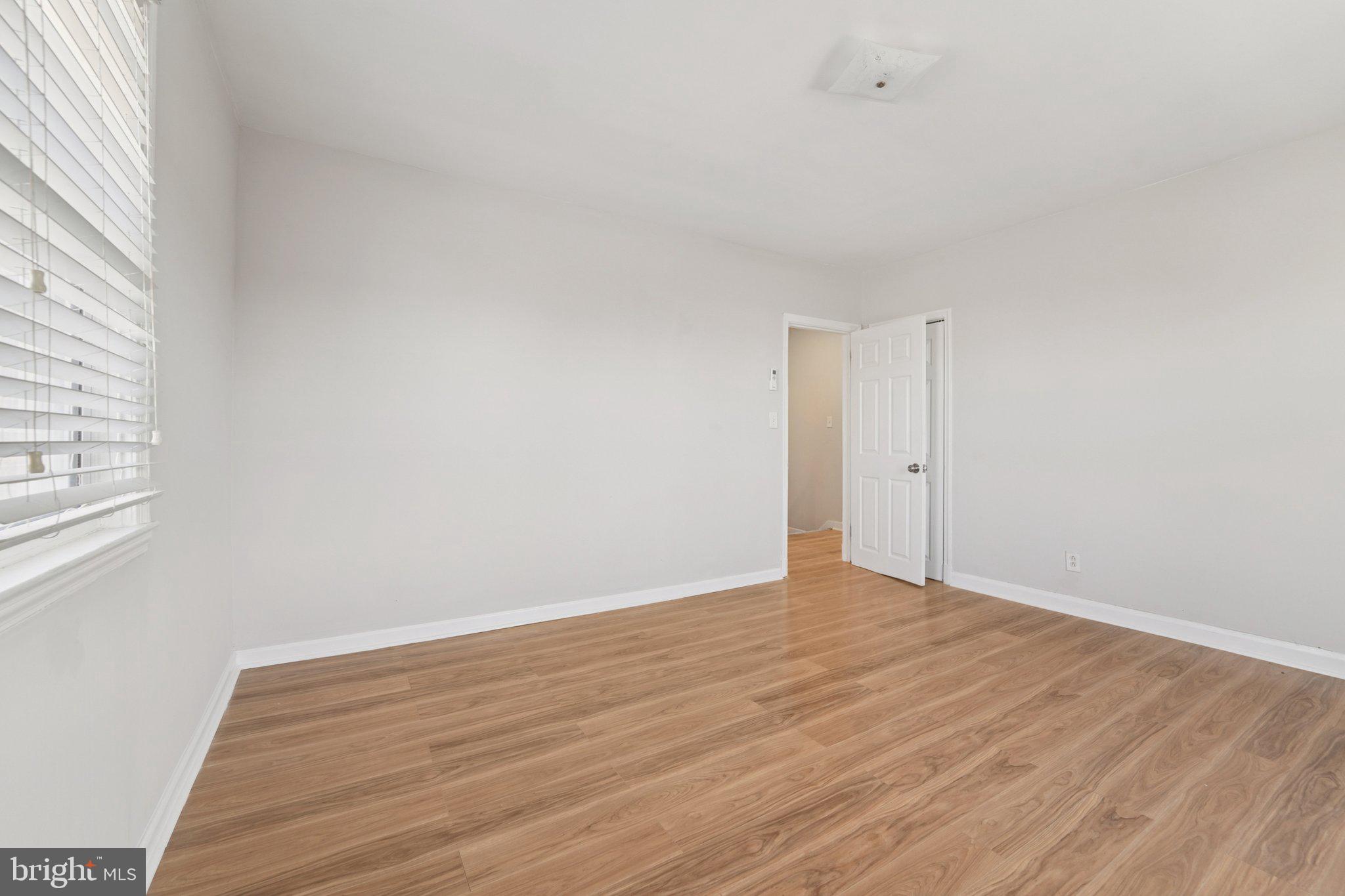 5701 The Alameda Baltimore, MD 21239 - Photo 19 of 29 a view of an empty room with wooden floor and a window