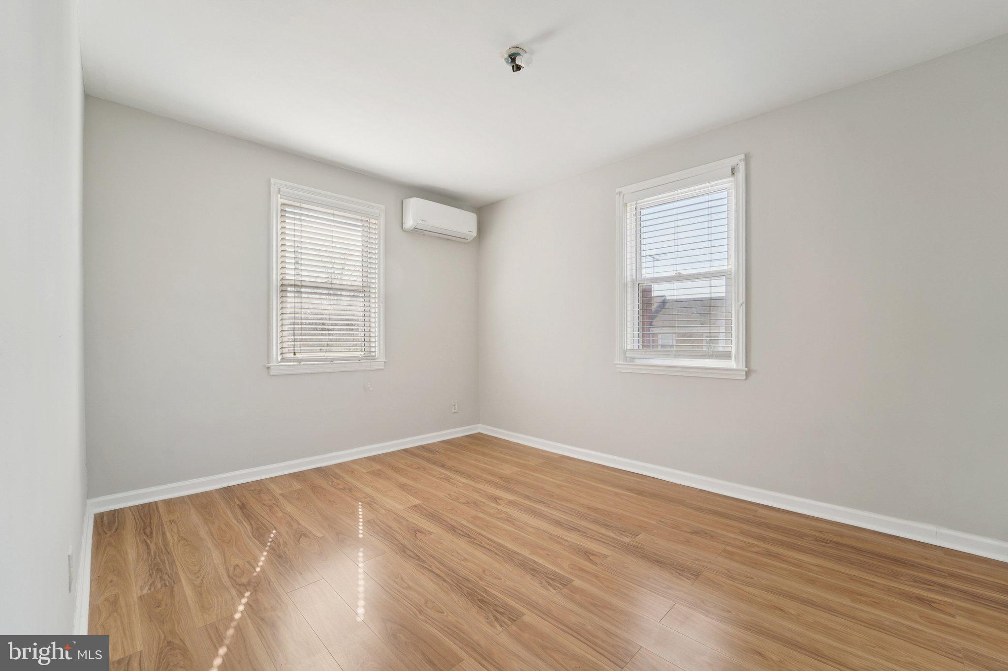 5701 The Alameda Baltimore, MD 21239 - Photo 20 of 29 an empty room with wooden floor and windows