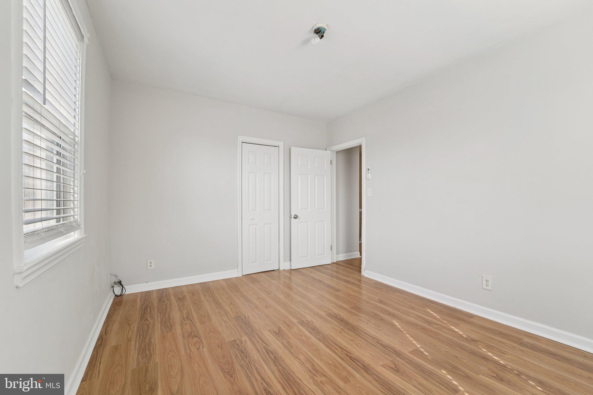 5701 The Alameda Baltimore, MD 21239 - Photo 21 of 29 a view of an empty room with wooden floor and a window