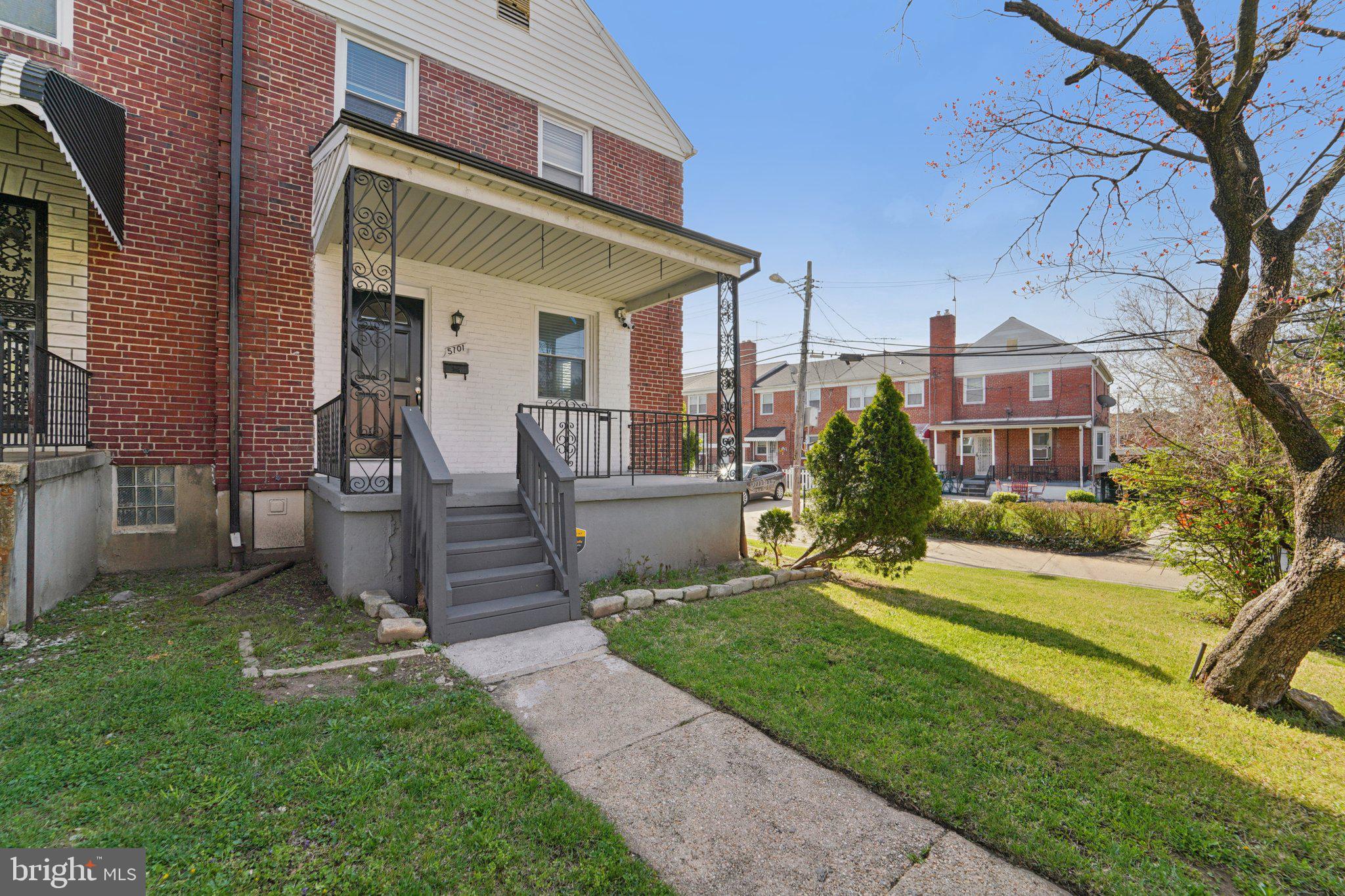 5701 The Alameda Baltimore, MD 21239 - Photo 4 of 29 a front view of a house with a yard