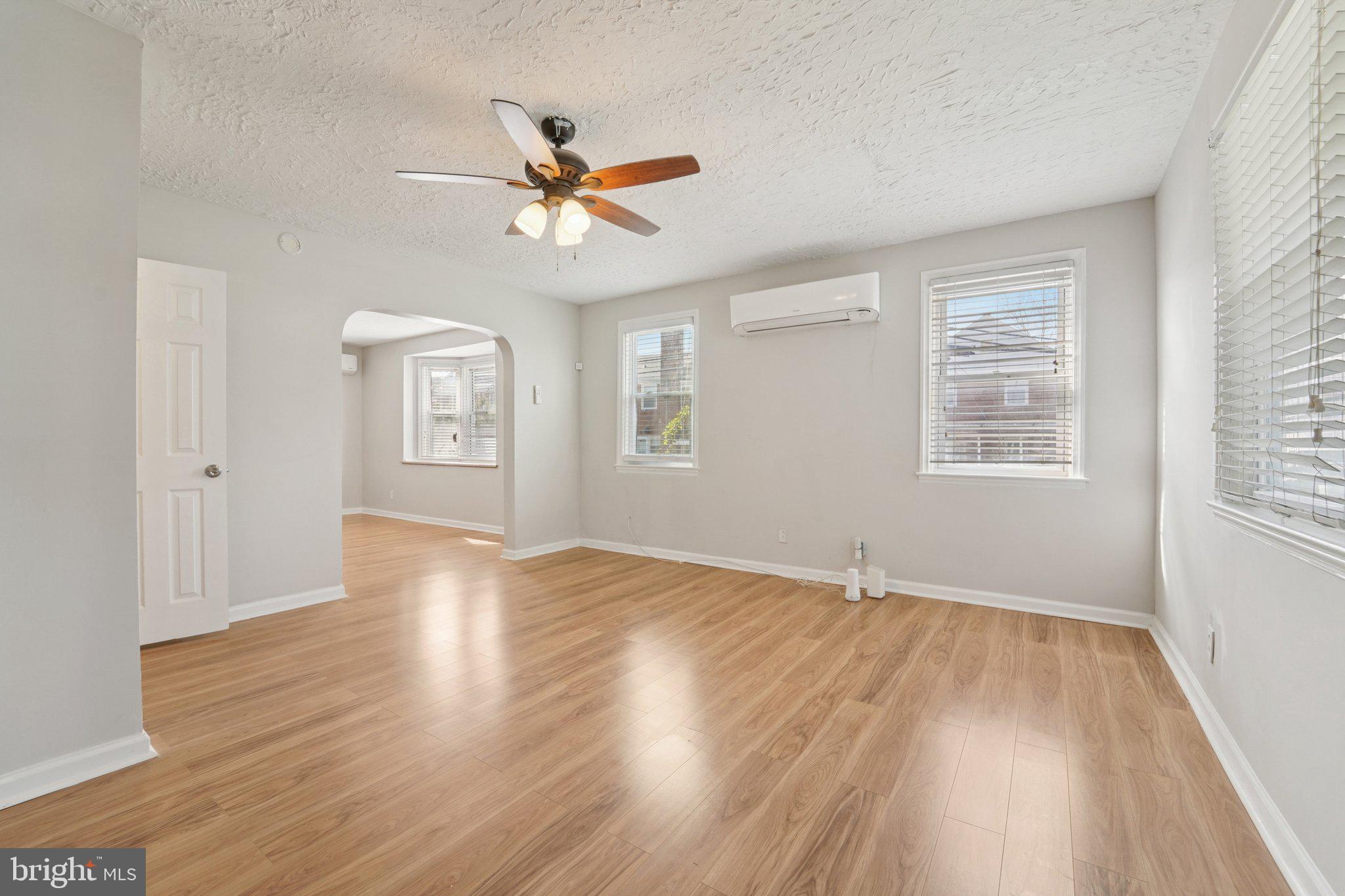 5701 The Alameda Baltimore, MD 21239 - Photo 6 of 29 a view of an empty room with wooden floor and a window