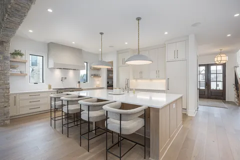 a view of a dining room with furniture a chandelier and wooden floor
