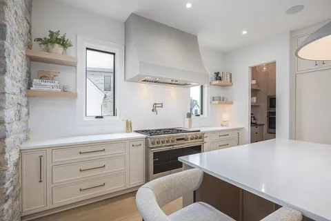 a living room with furniture and a dining table with kitchen view