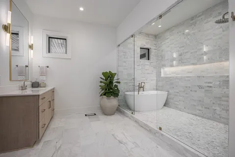 a bathroom with a toilet a sink and a mirror