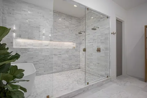 a spacious bedroom with a bed and a large window