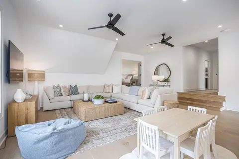a bedroom with a bed wooden floor and window
