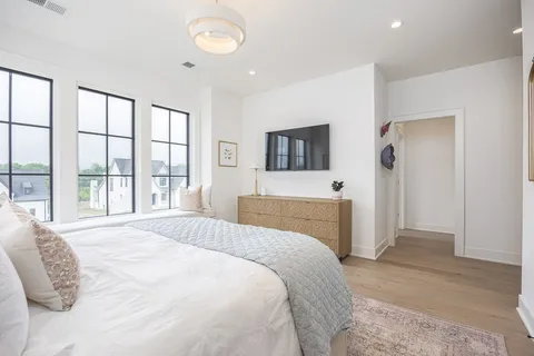 an aerial view of residential houses with outdoor space and trees