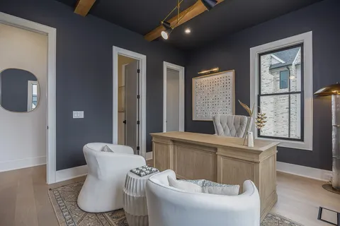 a kitchen with stainless steel appliances kitchen island granite countertop a table chairs and a refrigerator