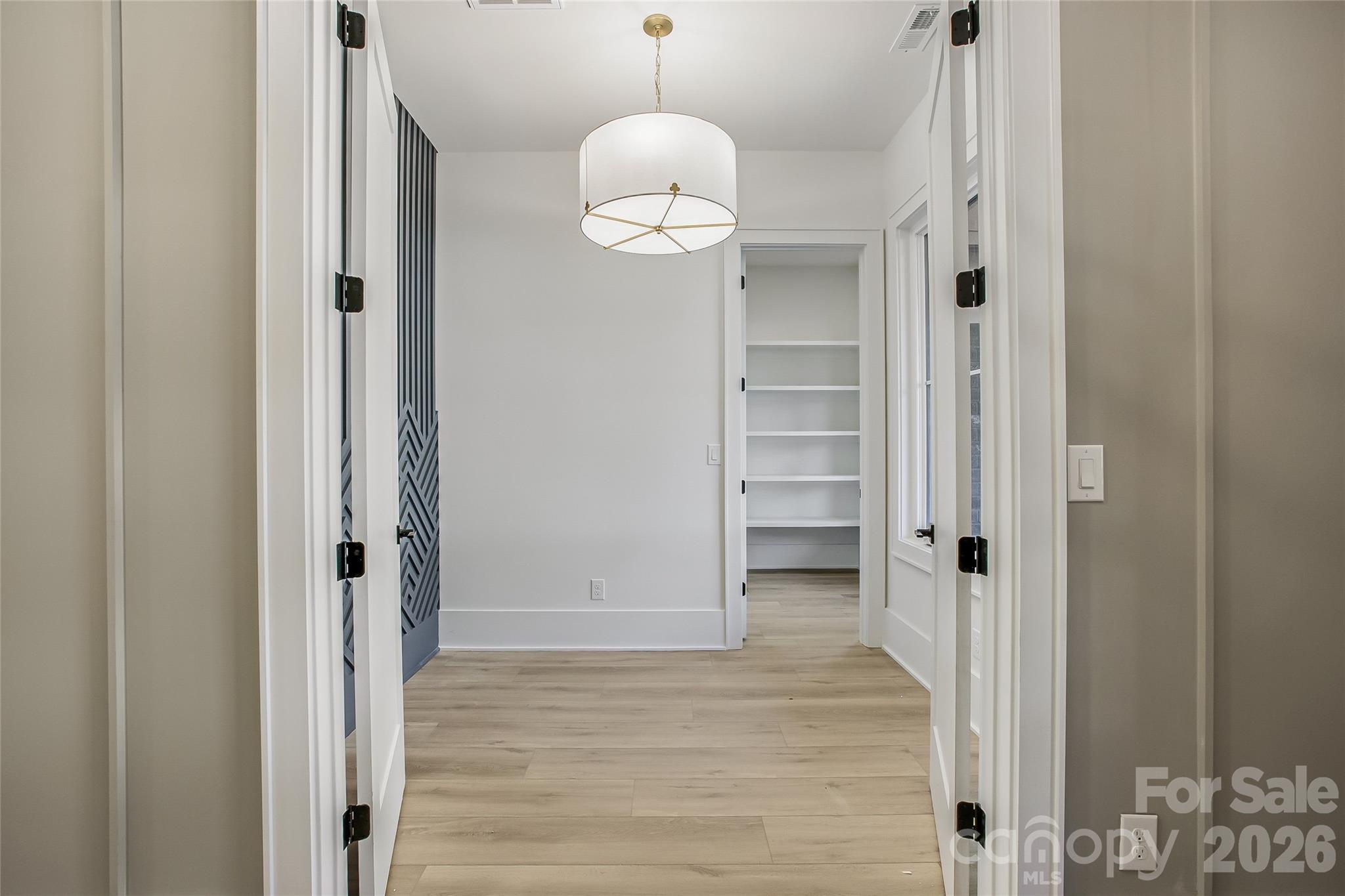 4221 Spring Street Charlotte, NC 28270 - Photo 11 of 44 a view of a hallway with wooden floor