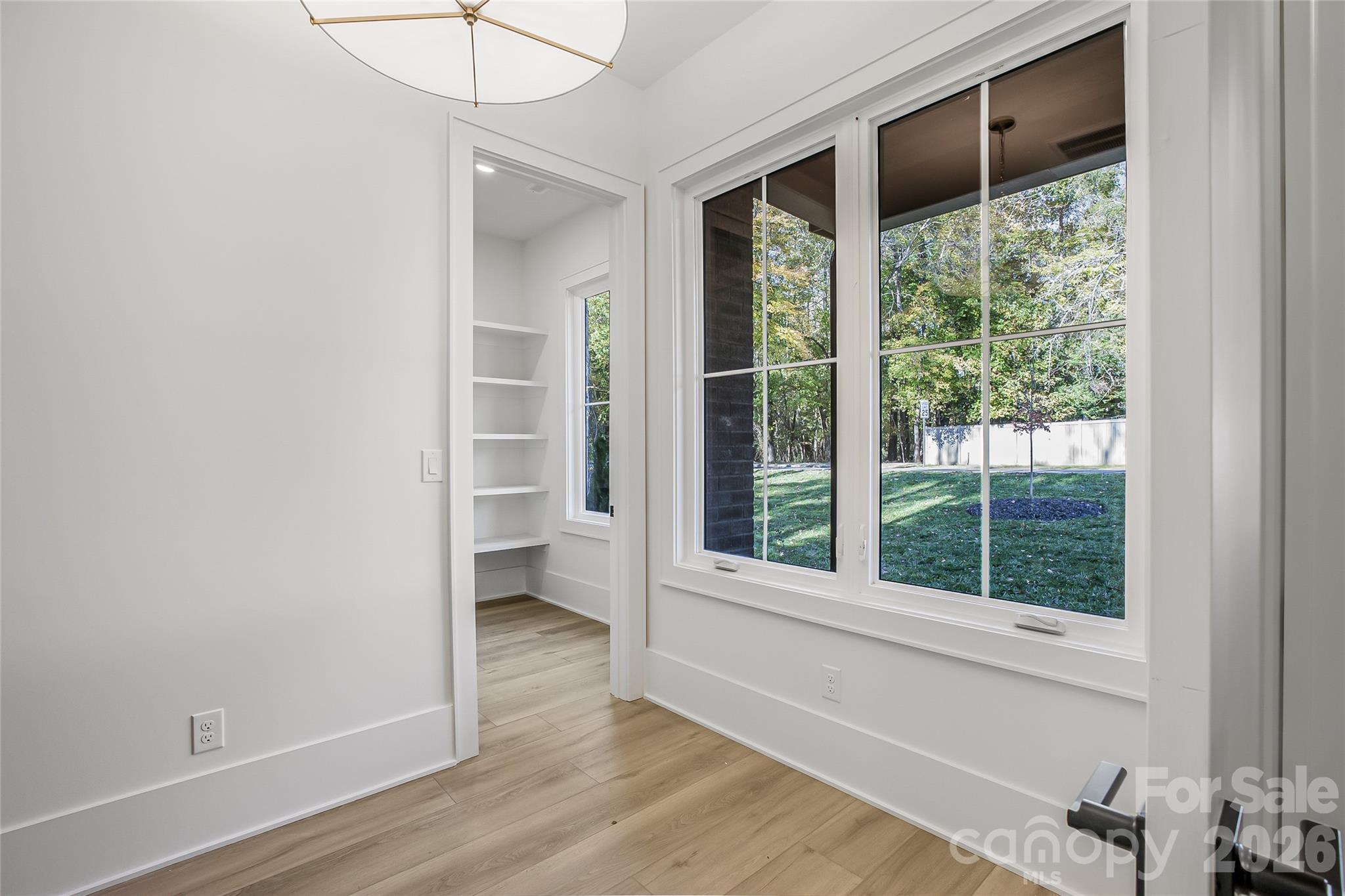 4221 Spring Street Charlotte, NC 28270 - Photo 12 of 44 a view of an empty room with a window and wooden floor