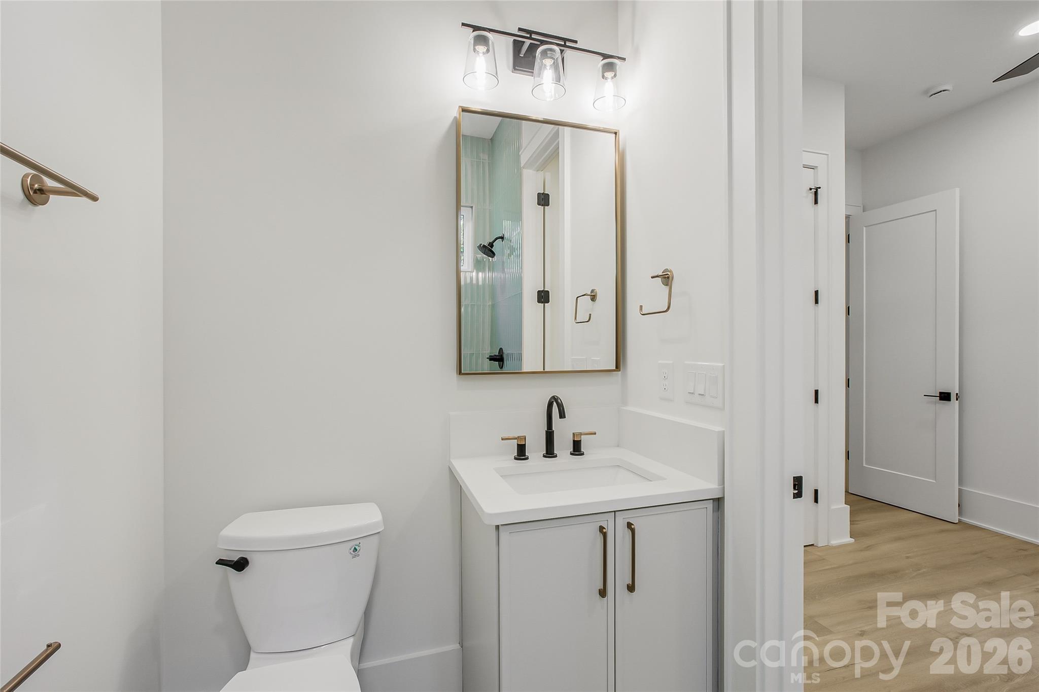 4221 Spring Street Charlotte, NC 28270 - Photo 16 of 44 a bathroom with a toilet sink and mirror