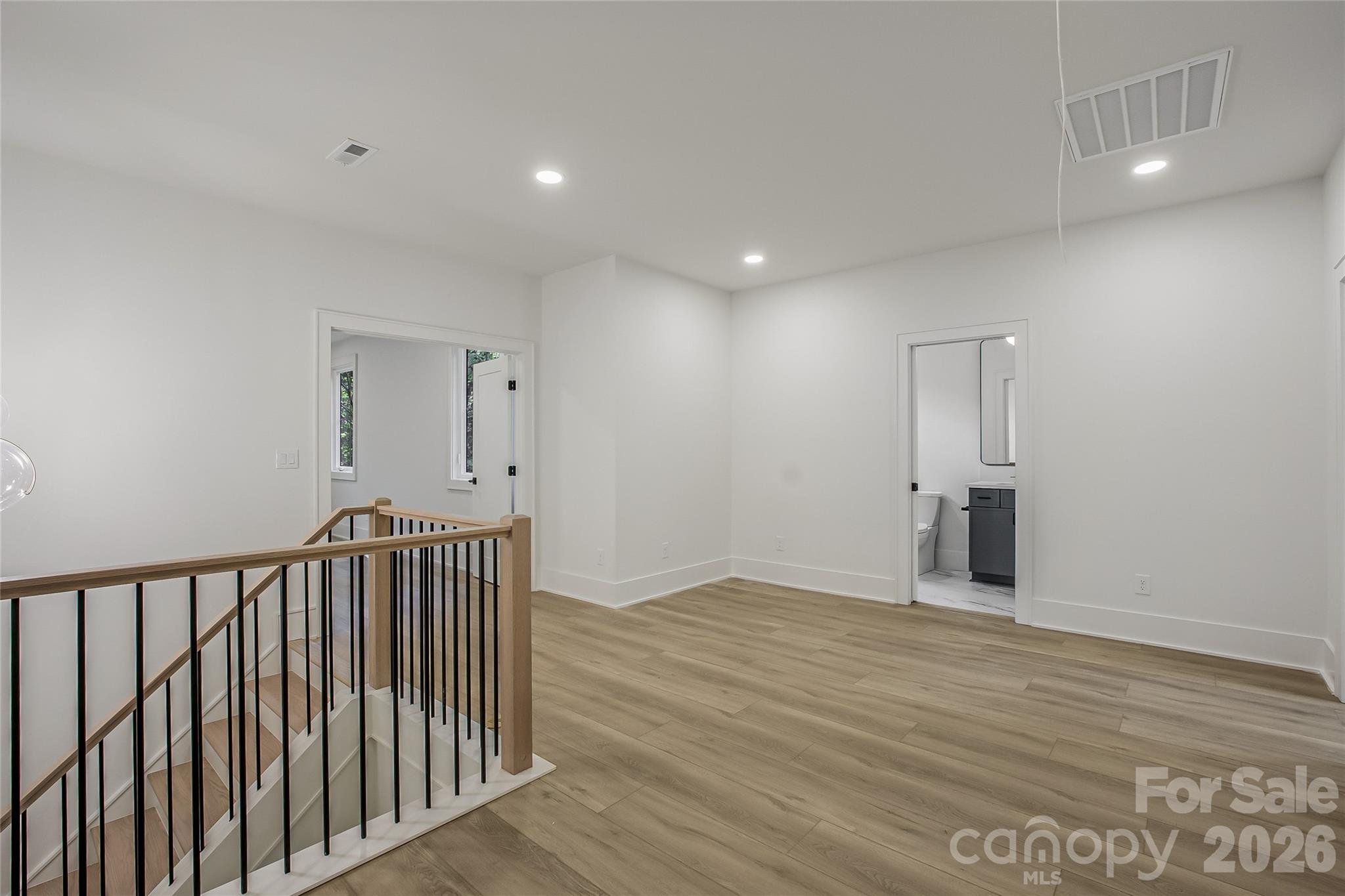 4221 Spring Street Charlotte, NC 28270 - Photo 19 of 44 a view of a hallway with wooden floor