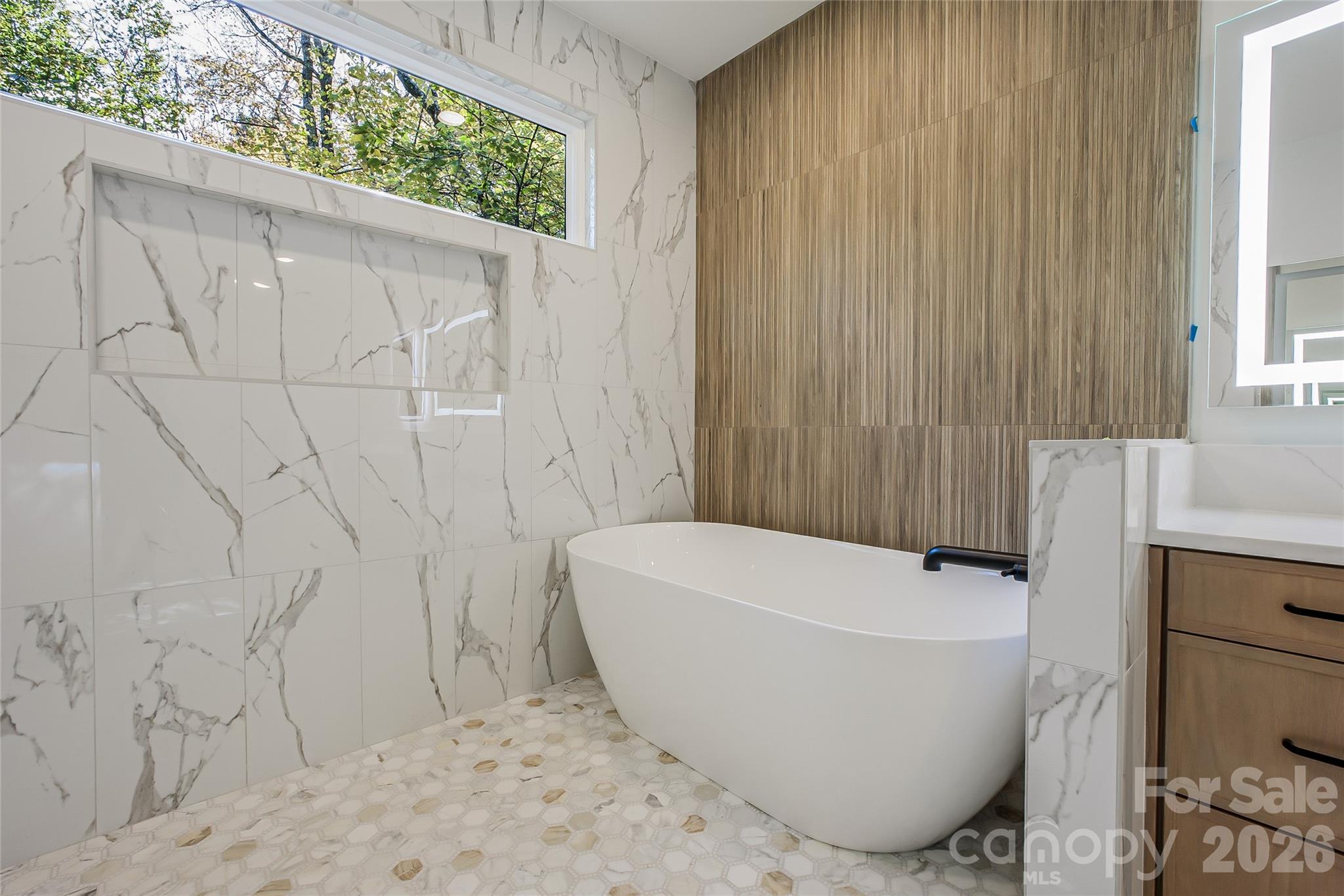4221 Spring Street Charlotte, NC 28270 - Photo 22 of 44 a view of a bathtub in a bathroom