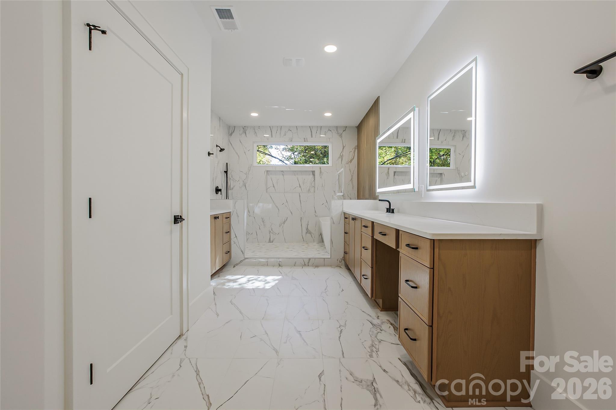 4221 Spring Street Charlotte, NC 28270 - Photo 26 of 44 a bathroom with a sink a mirror and a bathtub