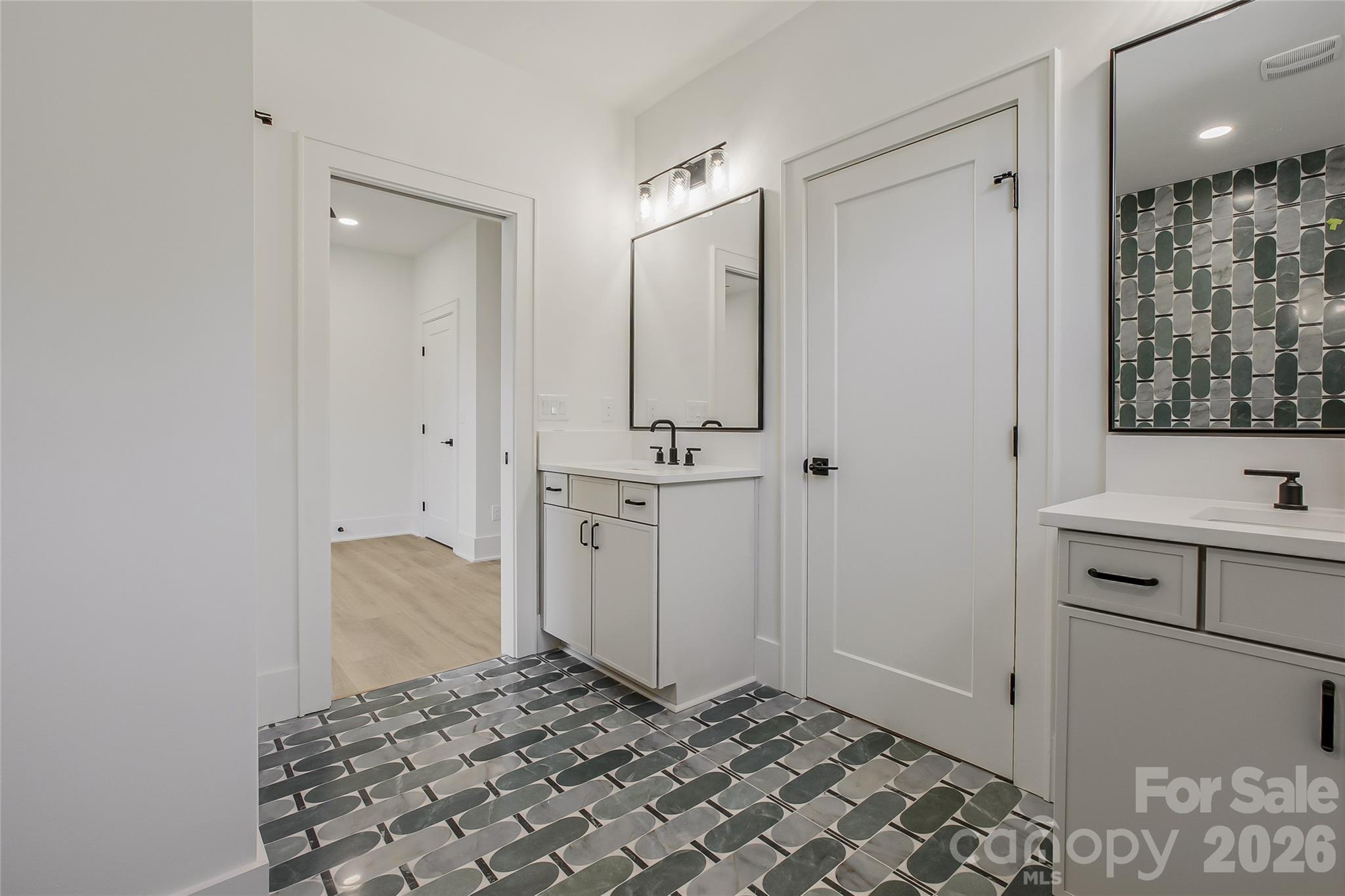 4221 Spring Street Charlotte, NC 28270 - Photo 30 of 44 a bathroom with a sink and a mirror