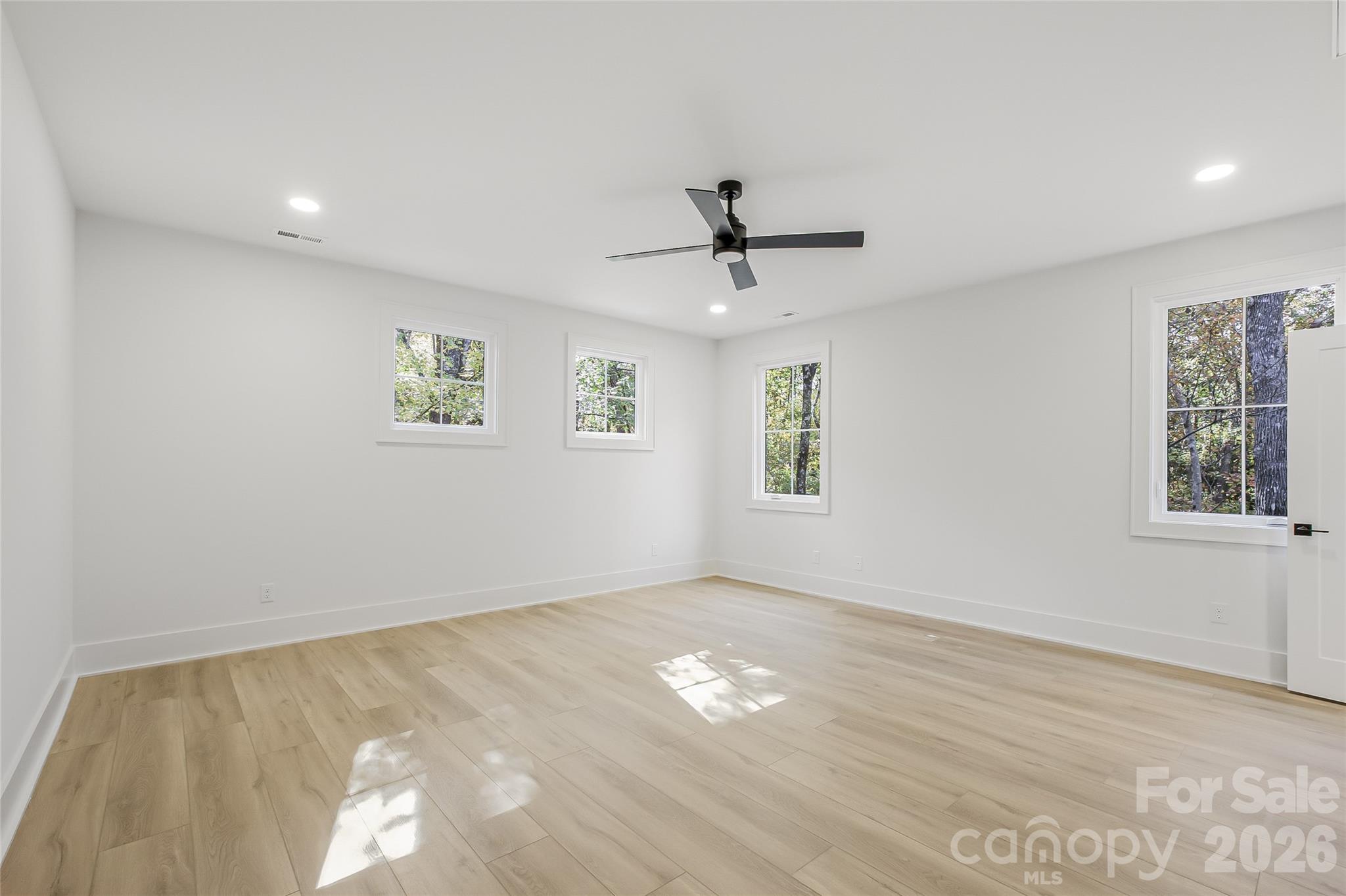 4221 Spring Street Charlotte, NC 28270 - Photo 37 of 44 a view of empty room with wooden floor and fan
