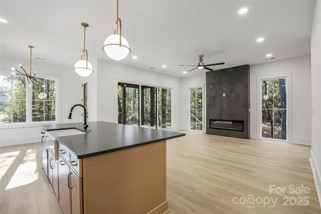 a view of a kitchen with sink and window