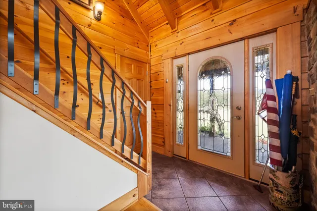 a kitchen with granite countertop a stove and white cabinets