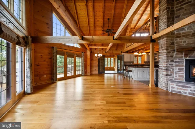 a large kitchen with stainless steel appliances granite countertop a sink a stove and a wooden cabinets