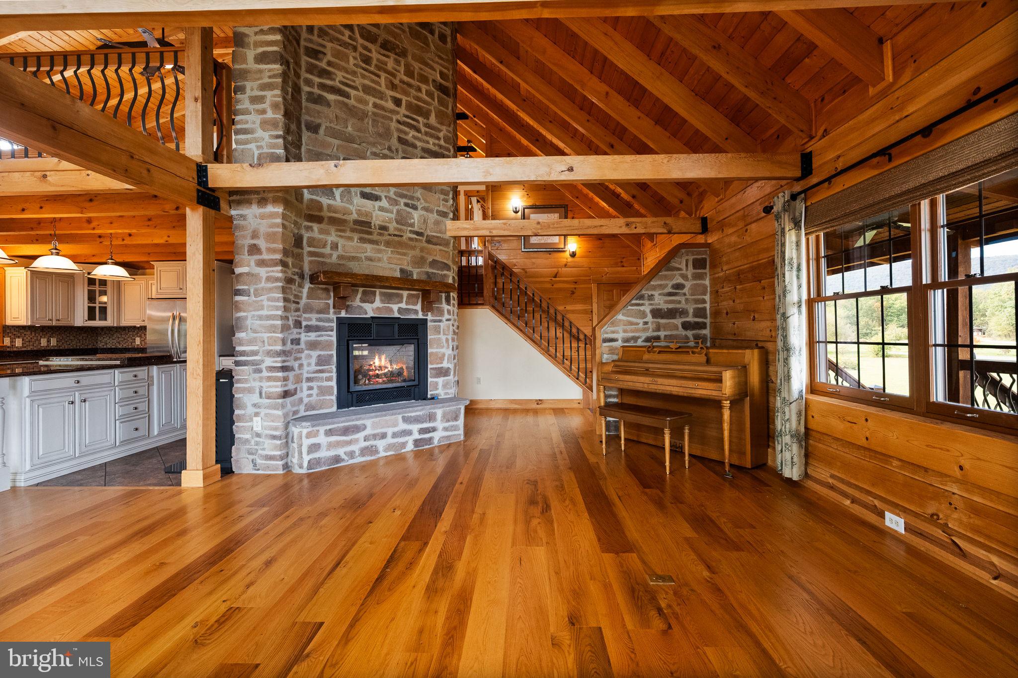 447 Fable Road Hedgesville, WV 25427 - Photo 14 of 81 a living room with a wooden floors and a fireplace